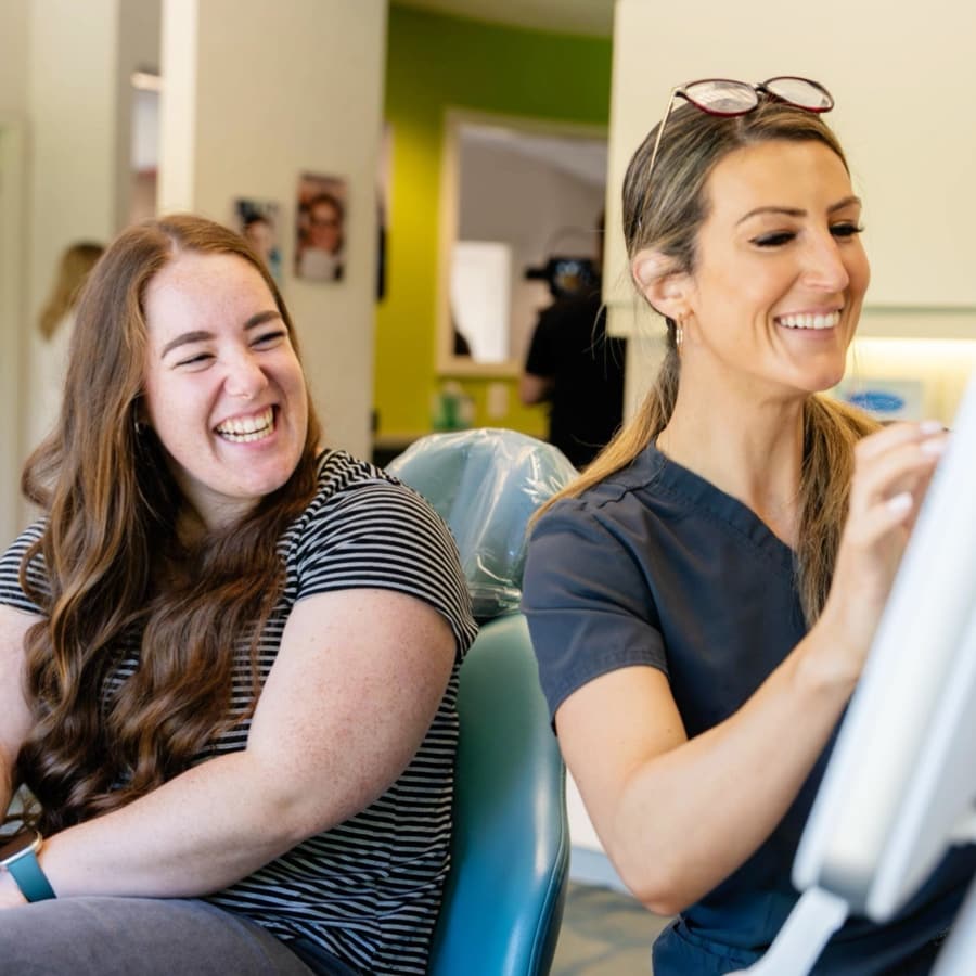 orthodontic patient laughing and smiling looking at digital scans